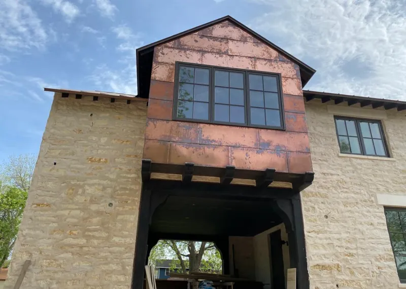 Copper metal panel facade on a stone building for Skylight Installation in Jenks